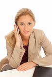 Portrait of young business girl sitting at desk with cell phone