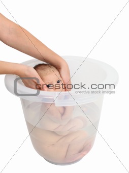 Baby taking a bath in bucket