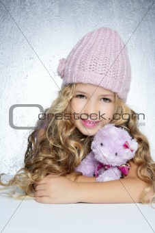 winter fashion cap little girl hug teddy bear smiling