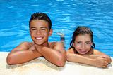 teen boy and little girl summer vacation in blue pool