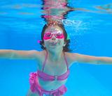 underwater little girl pink bikini blue swimming pool