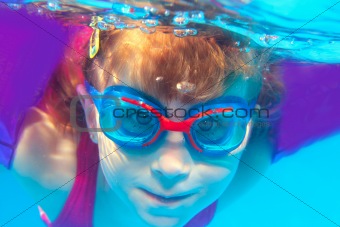 Underwater swimming girl goggles blue water