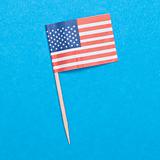 American Flag Toothpick on a Blue Background.