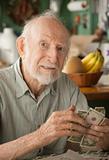 Senior man at home counting money
