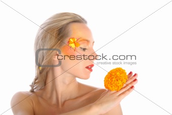 Surprised young woman with yellow flower