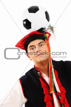 Polish man in a traditional outfit with football on head
