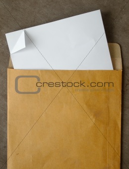 White paper from a brown open envelope