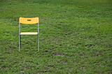 Yellow Chair in Green Grass