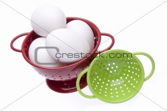 Red and Green Colanders with Fresh Eggs