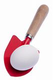 Red Shovel with Egg Isolated on White