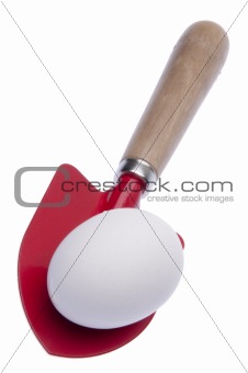 Red Shovel with Egg Isolated on White