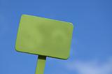 Green Sign on Bright Blue Cloudy Sky