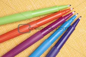 Vibrant Pens on Yellow Background
