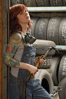 Female welder with tattoos