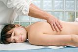 young caucasian woman lying down receiving back massage