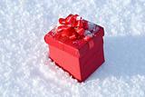 Red gift box on snow 