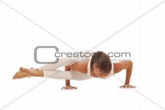 Young woman doing yoga Side Crow Pose