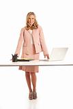 Young businesswoman with laptop standing at desk