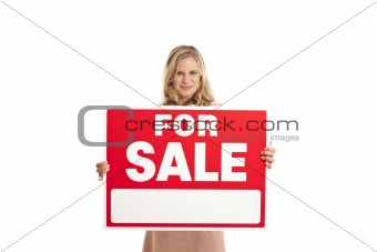 Young businesswoman holding for sale sign
