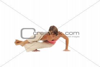 Young woman doing yoga Side Crow Pose