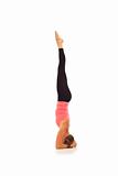 Young woman doing yoga Headstand Pose