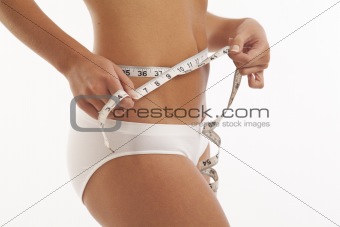 Young woman in underwear with measuring tape