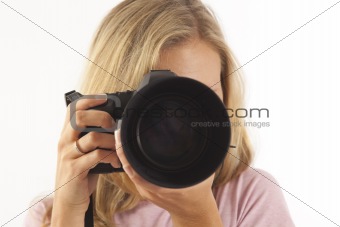 Young woman with camera taking a picture