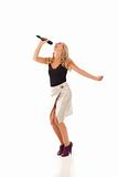 Young woman with microphone dancing and singing