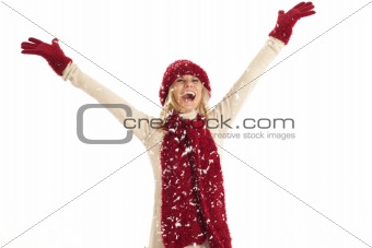 Young woman with red hat and scarf throwing snow