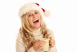 Young woman with Santa hat and coffee cup