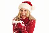 Young woman with Santa hat holding snow