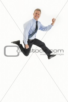Smiling young businessman jumping in air with happiness