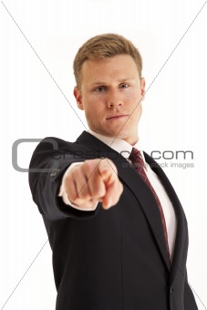 Portrait of serious young businessman pointing finger at camera