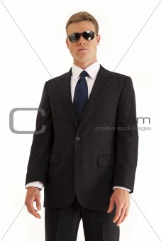 Portrait of serious young businessman wearing a suit and sunglasses