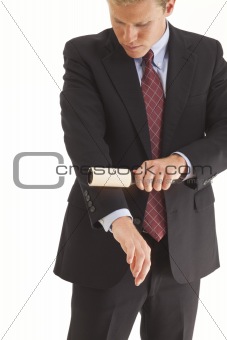 Young businessman using lint brush