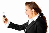 Amazed modern business woman yelling on cell phone
