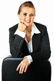 Portrait of smiling modern business woman leaning  on chair
