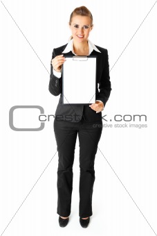 Full length portrait  of friendly modern business woman holding blank clipboard  in hands

