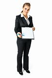 Full length portrait  of  friendly modern business woman with documents and pen for your sign
