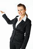 Smiling modern business female presenting something on empty hand
