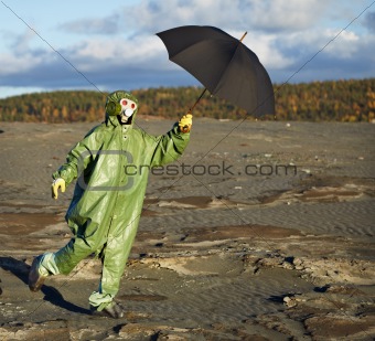 Person in protective scientific overalls with umbrella