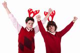 happy young men wearing reindeer horns, with arms raised, on white, studio shot