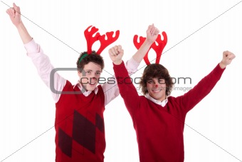 happy young men wearing reindeer horns, with arms raised, on white, studio shot