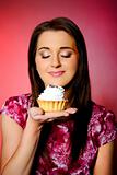 young beautiful girl eating small sweet cake. 