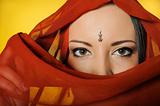 Young beautiful woman eyes in indian traditional jewellary, bind
