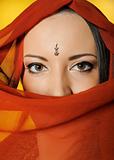 Young beautiful woman eyes in indian traditional jewellary, bind