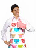Young man in apron preparing to cook romantic dinner