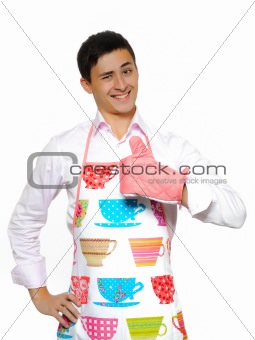Young man in apron preparing to cook romantic dinner