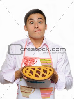 Young man in apron baked tasty pie. isolated on white background