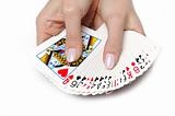 Beautiful hands with perfect  manicure holding a deck of playing cards